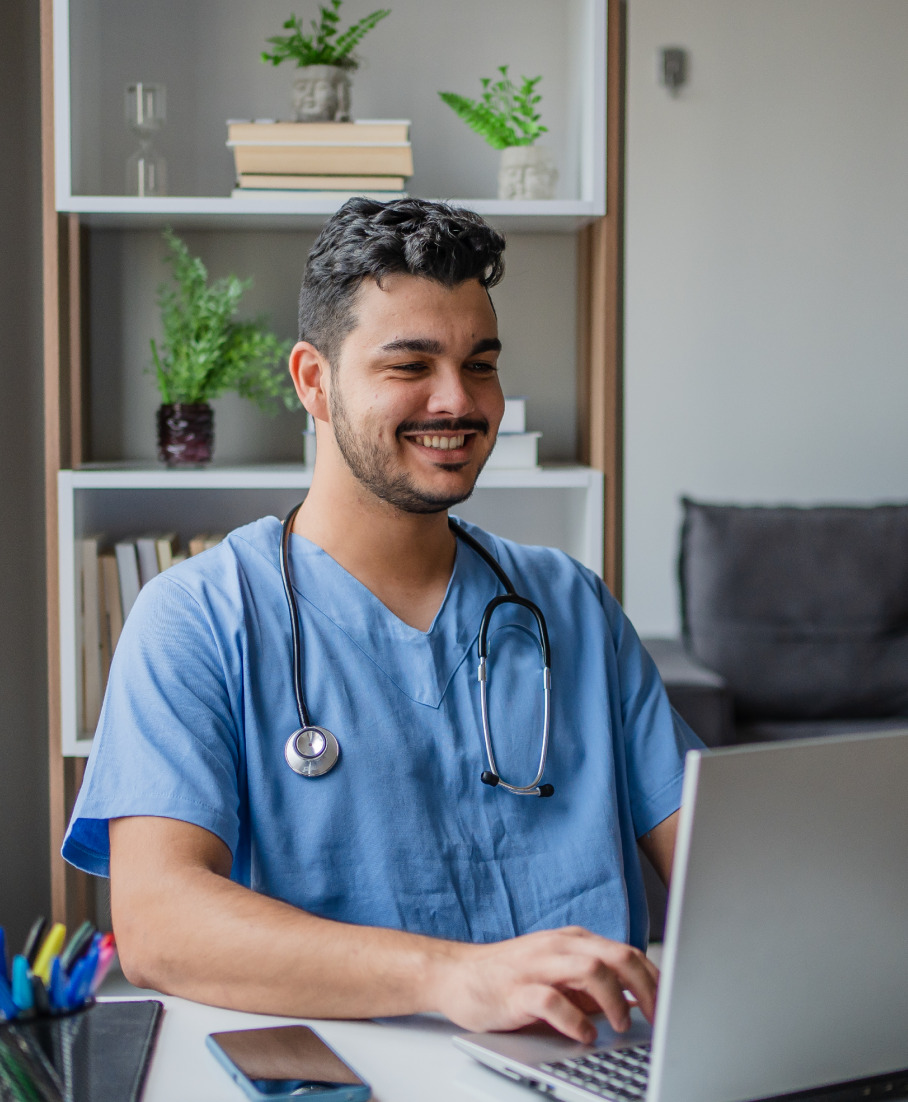 Male doctor using laptop
