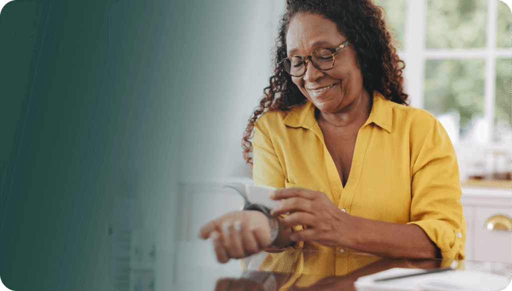 Woman measuring her own blood pressure with medical device