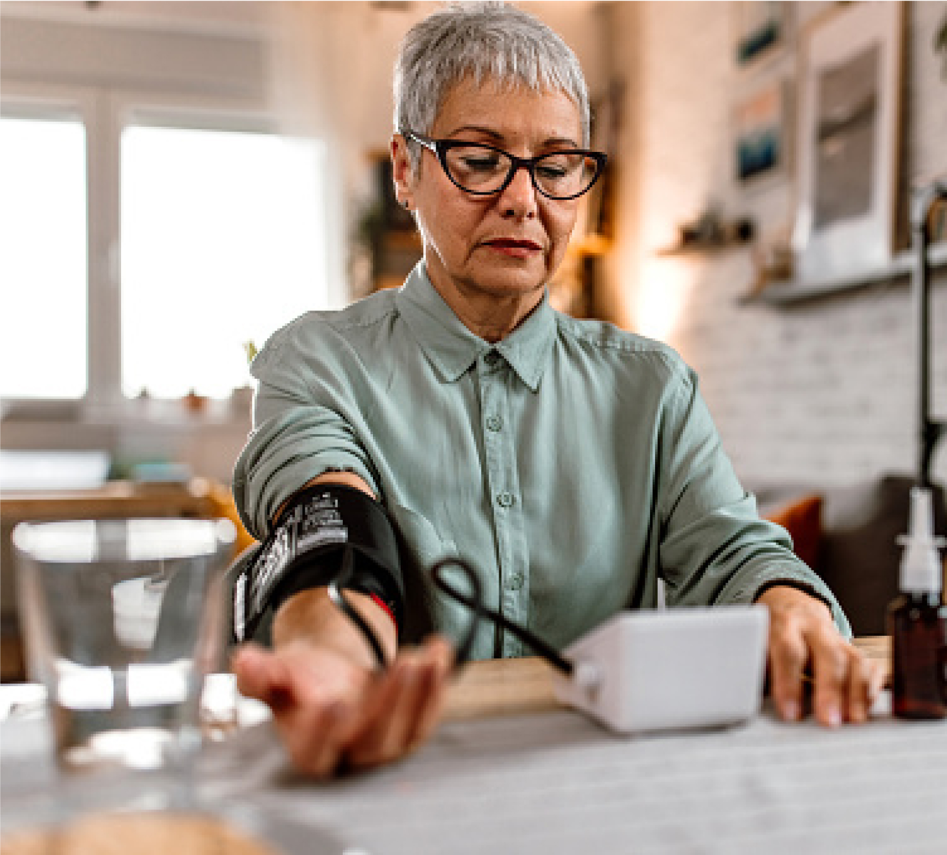 Elderly woman using blood pressure device