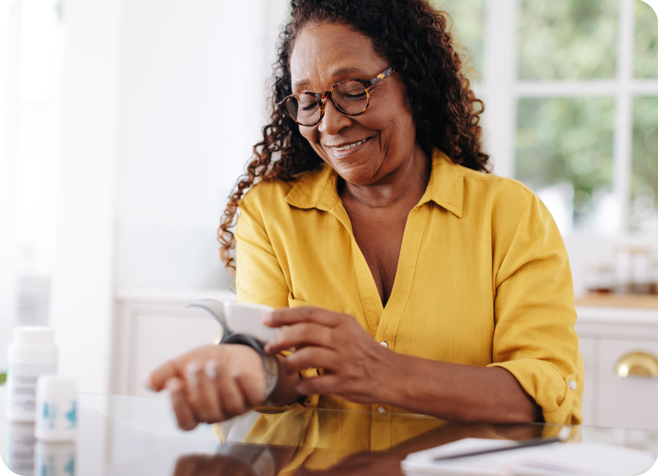 Elderly woman using blood pressure device