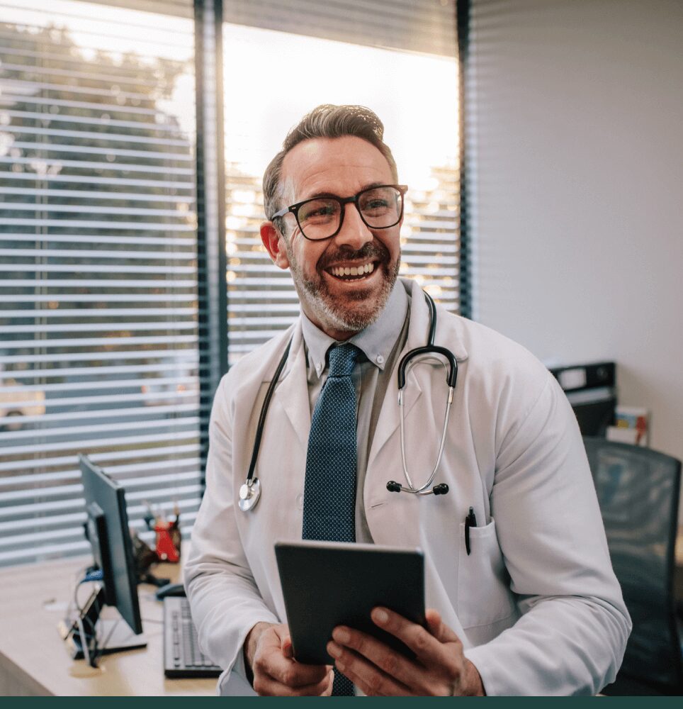 Smiling doctor with table