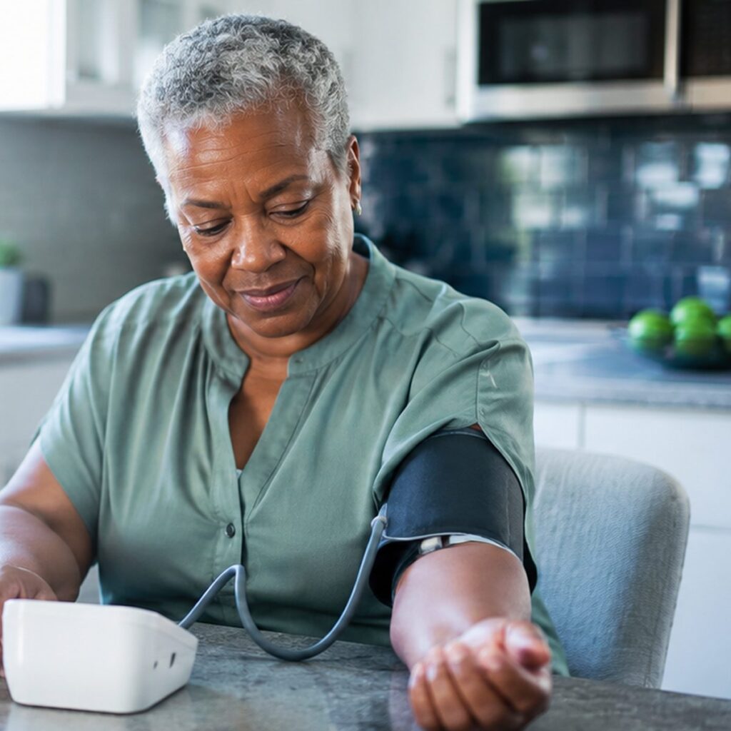 lder woman taking a home blood pressure reading, remote patient monitoring for Colorado Medicaid
