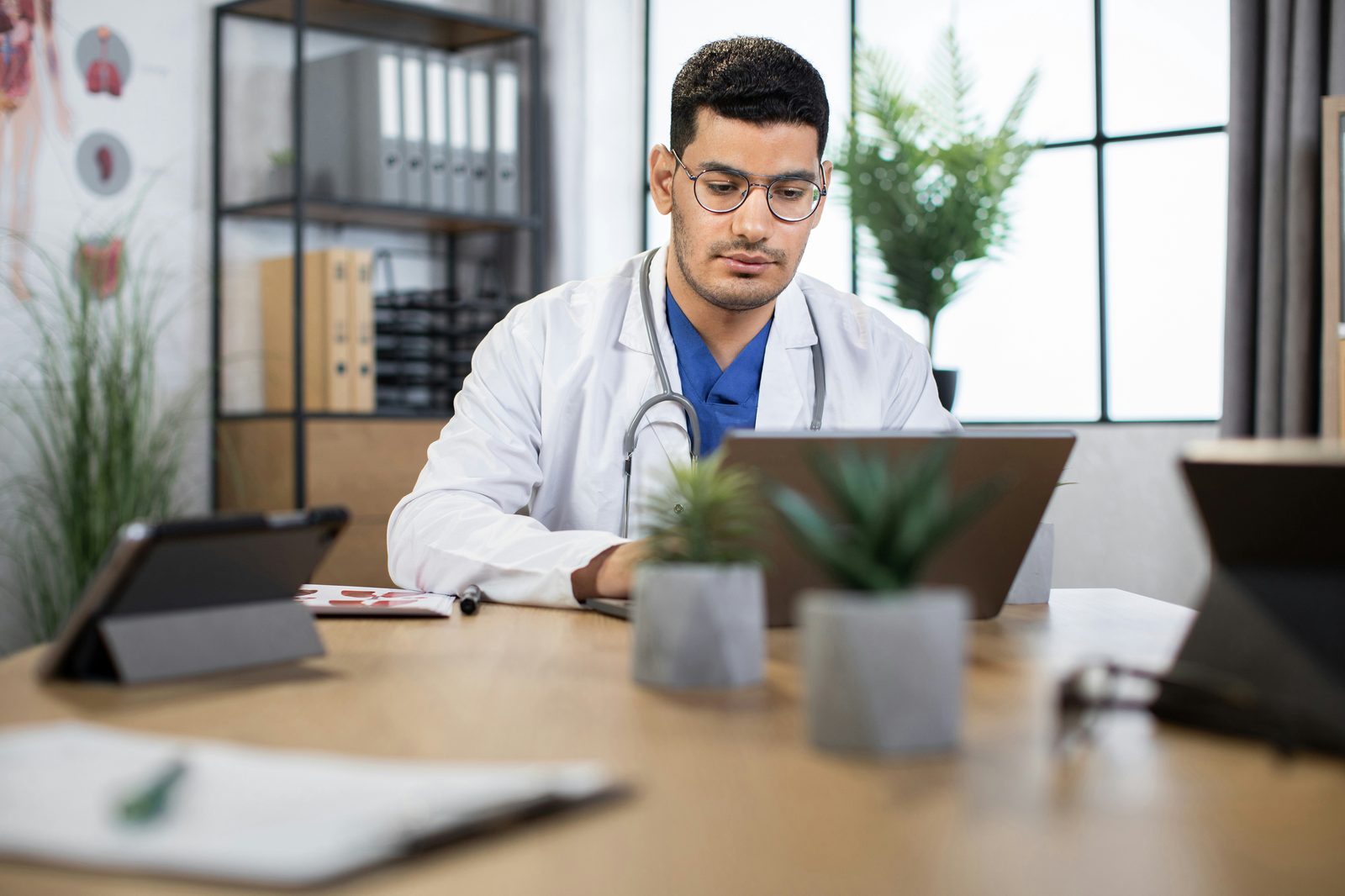 Clinician working securely on a laptop in a medical office, Vivo Care HIPAA compliant remote care platform